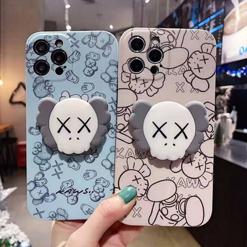 カウズ ブランドiphone13/12pro max/12 mini/12 pro maxケース ハンドバンド付き 韓国風 ホルダー付 KAWS 個性潮 iphone x/xr/xs/xs maxケース 落下防止 ファッション ins風 iphone 11/11 pro/11 pro maxケース かわいい iphone x/8/7 plusケース大人気